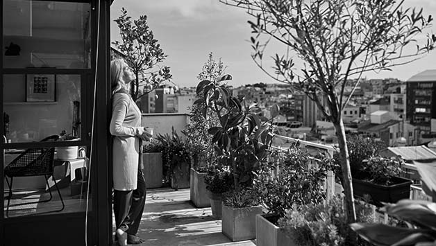 senior woman standing on balcony