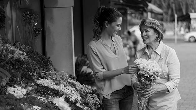 mother and daughter picking out flowers